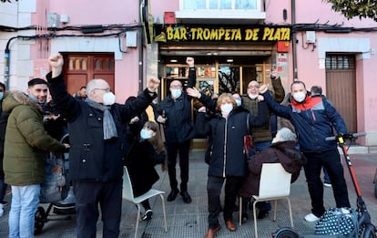 Varias personas celebran a las puertas del bar Trompeta de plata después de que el número que tenían abonado, el 41.665, resultara agraciado con el primer premio del sorteo extraordinario de la lotería del Niño, este jueves, en Logroño.