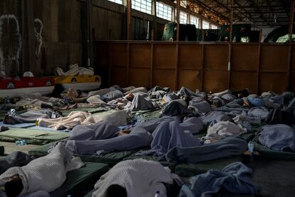 Survivors of a shipwreck sleep at a warehouse at the port in Kalamata town, about 240 kilometers (150 miles) southwest of Athens, on June 14, 2023.