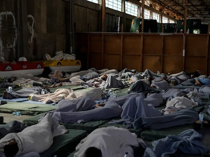 Survivors of a shipwreck sleep at a warehouse at the port in Kalamata town, about 240 kilometers (150 miles) southwest of Athens, on June 14, 2023.