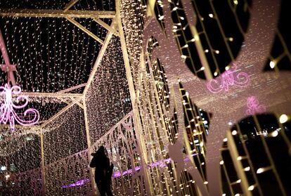 A woman tries to take a photo next to light-up decorations of annual Sapporo White Illumination event in Sapporo, northern Japan, November 24, 2016. REUTERS/Issei Kato