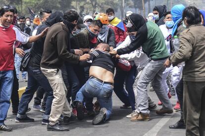 Un manifestante recibe ayuda de sus compañeros tras resultar herido.
