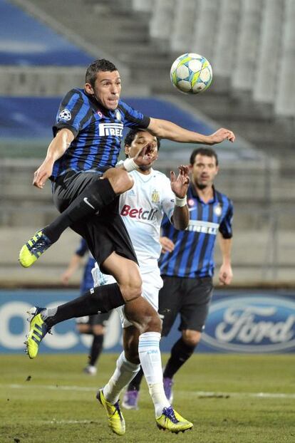 Lucio, del Inter, despeja el balón ante Brandao.