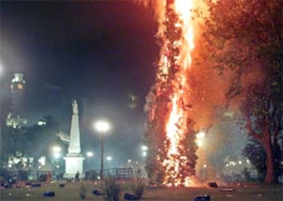 La llegada de la noche no disipó la violencia. En la imagen, la Plaza de Mayo muestra las secuelas de los enfrentamientos entre manifestantes y policías. Hasta entonces habían muerto 5 personas. (AFP)