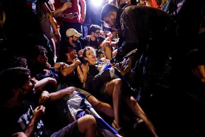 Protesters scuffle with police, during a demonstration, following a parliament vote on a contested bill that limits Supreme Court powers to void some government decisions, near the Knesset, Israel's parliament in Jerusalem