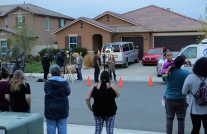 Vecinos y periodistas frente a la casa, en Perris, California.