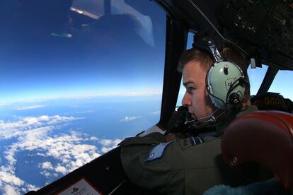 Russell Adams mira desde la cabina del avión AP-3C durante una misión de búsqueda de los restos del avión desaparecido de Malaysia Airline MH370 en el Océano Indico.