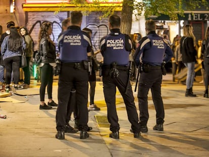 Police break up people drinking on the street in Madrid.