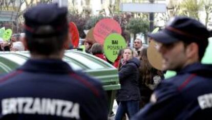 Agentes de la Ertzaintza custodian la zona de San Sebastián donde se ubica el despacho de abogados del diputado del PP José Eugenio Azpiroz, ante la presencia de un escrache convocado por la plataforma Stop Desahucios Gipuzkoa.