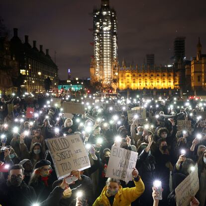 People flash lights from their mobile phones as they attend a protest at the Parliament Square, following the kidnap and murder of Sarah Everard, in London, Britain March 14, 2021. REUTERS/Henry Nicholls