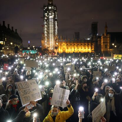 People flash lights from their mobile phones as they attend a protest at the Parliament Square, following the kidnap and murder of Sarah Everard, in London, Britain March 14, 2021. REUTERS/Henry Nicholls