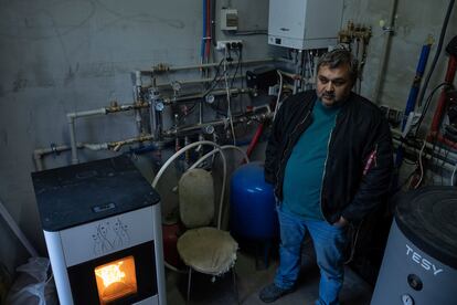 Andriy Gorghinskyyб 49, stands in his house with autonomous heating, in the village of Malyutyanka near Kyiv, Ukraine, Tuesday, Oct. 10, 2023.  Many Ukrainians are expecting the same or worse this coming winter and have spent months preparing, including collecting firewood and buying generators.(AP Photo/Alex Babenko)