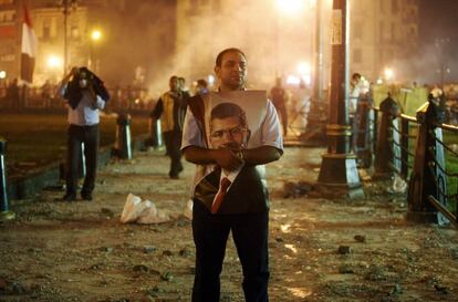 Un partidario de Mohamed Morsi sujeta un retrato del expresidente egipcio durante los enfrentamientos en El Cairo, 15 de julio de 2013.