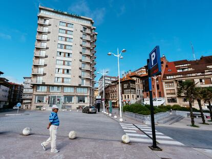 Un señor pasea por una calle cercana a un hotel en Candás, Asturias