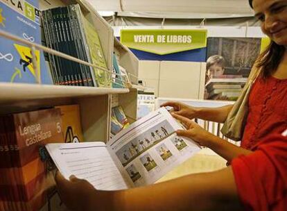 Dos personas observan libros de texto en un centro comercial en el Campo de las Naciones.