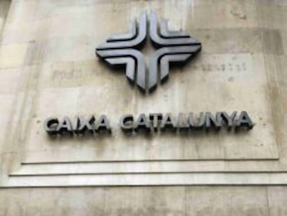 Un hombre camina junto a un edificio de Caixa Catalunya en Barcelona.