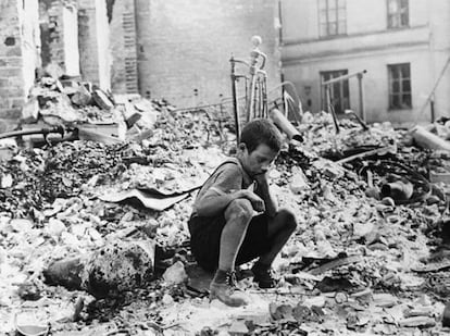 Un ni&ntilde;o entre las ruinas de una ciudad al acabar la II Guerra Mundial.