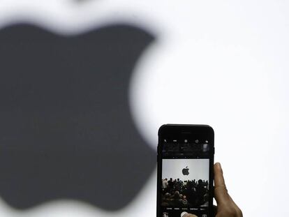 Una persona hace una foto del logo de Apple.