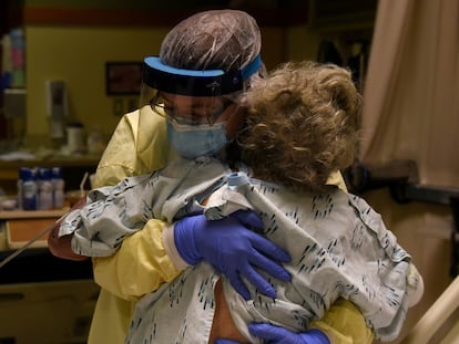 Enfermeira ajuda paciente com covid-19 em um hospital dos EUA, no Kansas, em novembro