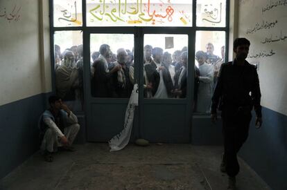 Cerca de 13 millones de personas están llamados a las urnas, aunque en las previsiones más optimistas no se espera una participación de mucho más del 50 % debido en gran parte a las amenazas de los talibanes de atacar los centros de votación. En la imagen, votantes afganos esperan la apertura de un centro electoral en Jalalabad.