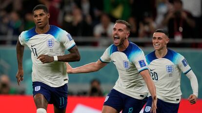 England's Marcus Rashford, left, celebrates with teammates after scoring the opening goal during the World Cup group B soccer match between England and Wales, at the Ahmad Bin Ali Stadium in Al Rayyan , Qatar, Tuesday, Nov. 29, 2022. England won 3-0. (AP Photo/Frank Augstein)