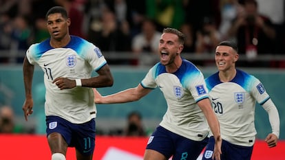 England's Marcus Rashford, left, celebrates with teammates after scoring the opening goal during the World Cup group B soccer match between England and Wales, at the Ahmad Bin Ali Stadium in Al Rayyan , Qatar, Tuesday, Nov. 29, 2022. England won 3-0. (AP Photo/Frank Augstein)