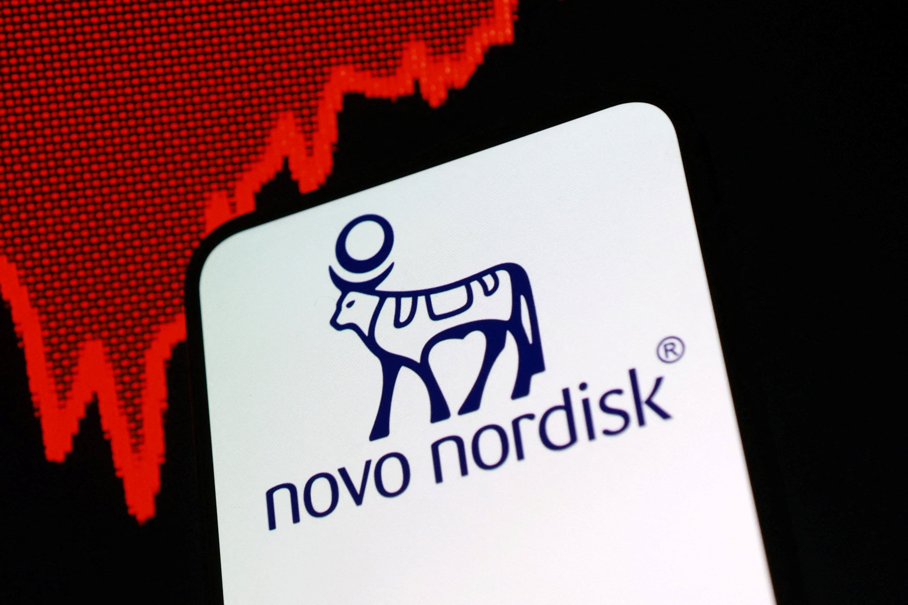 Logo de Novo Nordisk sobre un gráfico de caída en Bolsa.