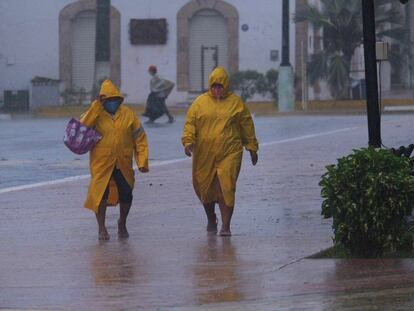 Dos personas caminan en medio de la tormenta en el poblado de Tizimin, Yucatán.