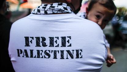 A man holds his daughter outside the US embassy in Kuala Lumpur, Malaysia on April 29, 2022.