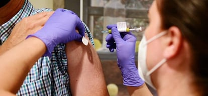 A volunteer is inoculated with the Janssen vaccine.