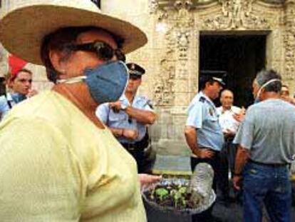 En la fotografía, una mujer con un plato repleto de moscas, que intentó sin éxito entregar al alcalde.