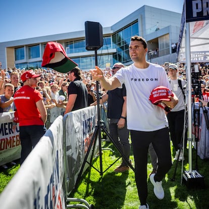 Charlie Kirk hands out hats before speaking at Utah Valley University in Orem, Utah, Wednesday, Sept. 10, 2025. (Tess Crowley/The Deseret News via AP)
