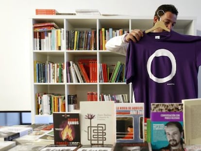 A Podemos supporter holds up one of the party’s shirts in Madrid.