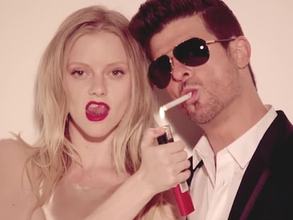Elle Evans and Robin Thicke in the 'Blurred Lines' music video.