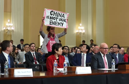 A protester disrupts the first hearing of the U.S. House Select Committee on Strategic Competition between the United States and the Chinese Communist Party as (L-R) Scott Paul, president of the Alliance for American Manufacturing, human rights activist Tong Yi, and Lt. Gen. H.R. McCaster (Ret.) testify, at the Cannon House Office Building on February 28, 2023 in Washington, DC.