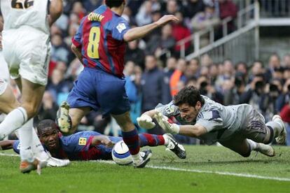 Casillas se lanza a los pies de Giuly, con Eto'o caído en el suelo.