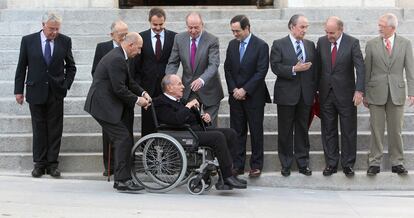 El senador Fraga es conducido al lugar que le corresponde para tomar la fotografía de familia de los protagonistas del 23-F.