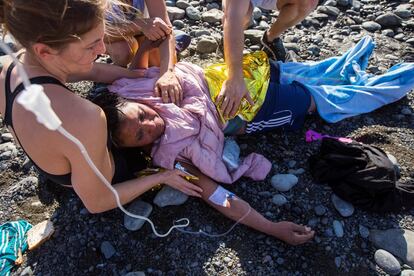 "Bastantes de ellos han llegado con dolores abdominales, con ampollas y cansados", ha detallado el vicepresidente de Cruz Roja en Canarias, Gerardo Santana Cazorla. Algunas personas que se encontraban en la playa en el momento de la llegada ayudan a una mujer a la que se le administra suero por vía intravenosa.