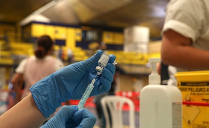 A nurse extracts an AstraZeneca dose.