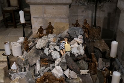 An installation of a scene of the Nativity of Christ with a figure symbolizing baby Jesus lying amid the rubble, in reference to Gaza, inside the Evangelical Lutheran Church in the West Bank town of Bethlehem, Sunday, Dec. 10, 2023.