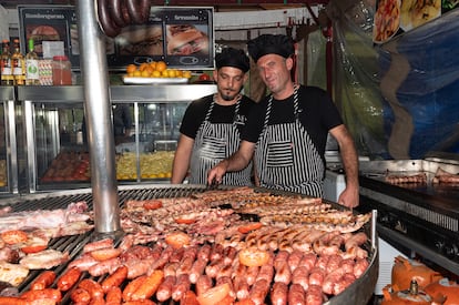 Antonio Jesús Riñones (derecha), conocido como 'Riñones Jesús', y Mario, trabajan en la Taberna Valentín, de Linares. llevan 17 años viniendo a la Feria de San Isidro. En su parrilla preparan productos de la Sierra de Cazorla. 