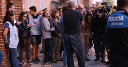 A crowd forms outside the apartment block in Alcorcón on Tuesday.