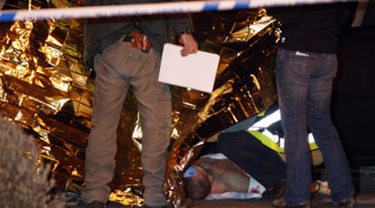 Agentes de policía, junto al cadáver en la glorieta Francisco Cabezas de Madrid.