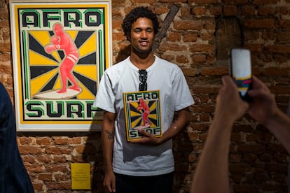 Michael February, surfista internacional nacido en Sudáfrica, posa con un ejemplar del libro 'Afro Surf' durante la presentación del mismo en Ciudad del Cabo, Sudáfrica, el 12 de diciembre de 2020. Haz click sobre la imagen para ver la fotogalería completa. 