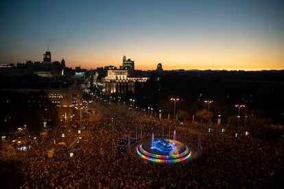 La fuente de la Cibeles iluminada con los colores del arcoíris al anochecer.