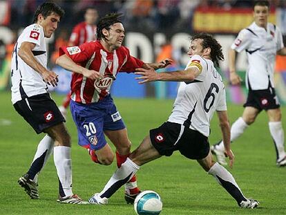 Gaby Milito frena en falta a Maniche.