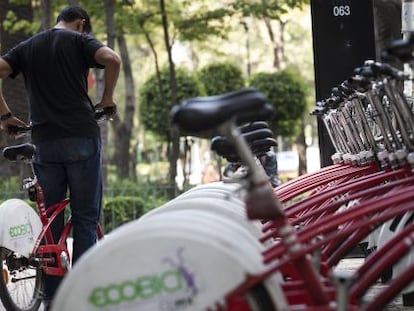 A cyclist checks out an Ecobici bike in Mexico City.