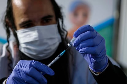 Trabalhador prepara dose da vacina da Pfizer para aplicação em Jerusalém, no domingo.