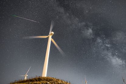 Perseid meteor and the Milky Way over the Wind Turbines of Greece's largest Wind Farm at Panachaiko mountain in Patras, Greece‬.