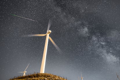 Perseid meteor and the Milky Way over the Wind Turbines of Greece's largest Wind Farm at Panachaiko mountain in Patras, Greece‬.