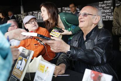 El escritor griego Petrus Markaris firma libros en las Ramblas de Barcelona, durante la Diada de Sant Jordi.